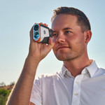 Male golfer looking through Tour V6 Shift Laser Rangefinder White Variant