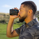 Male golfer looking through Tour V6 Shift Laser Rangefinder Black Variant